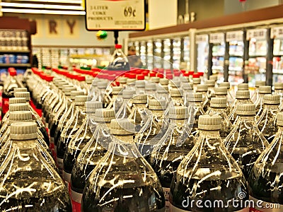 Rows of bottled beverages stacked on shelves Editorial Stock Photo