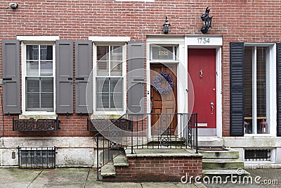 Rows of brownstone apartment buildings in Center City with windows, stoops and planters in Pennsylvania Editorial Stock Photo
