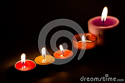 Rows of burning colorful candles Stock Photo