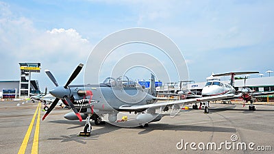 Rows of business and military aircraft on display, including the Beechcraft King Air 350ER and Beechcraft AT-6 Texan II fighter Editorial Stock Photo