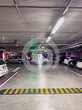 Budva, Montenegro - 09 august 2023: Rows of cars stand in a lighted underground parking Editorial Stock Photo