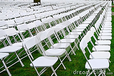 Rows of chairs form a beautiful pattern on the grass land Stock Photo