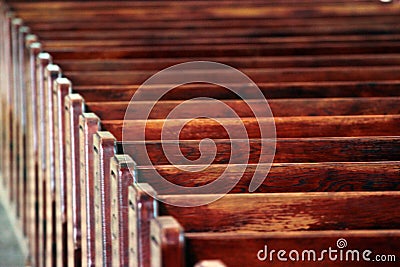 Rows of church benches. Polished wooden pews. Blurred focus Stock Photo