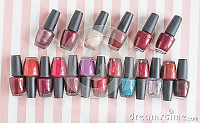 Rows of Nail Polish on Pink and White Fabric Stock Photo