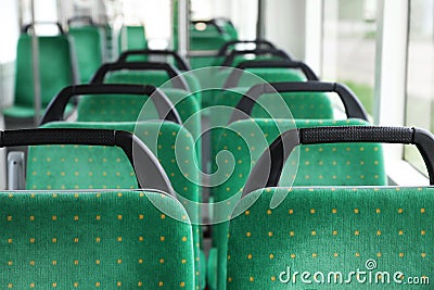 Rows of comfortable green seats in public transport Stock Photo