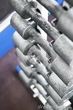 Rows of dumbbells in the gym. Dumbbell set. Many metal dumbbells on rack in sport fitness center. Top view Stock Photo