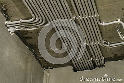 Rows of electrical cables laid in the corrugates on the ceiling Stock Photo