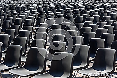 Rows of empty black plastic seats Stock Photo