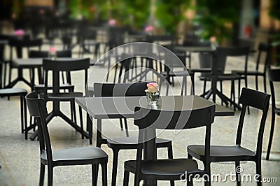 Rows of empty black restaurant terrace tables Stock Photo