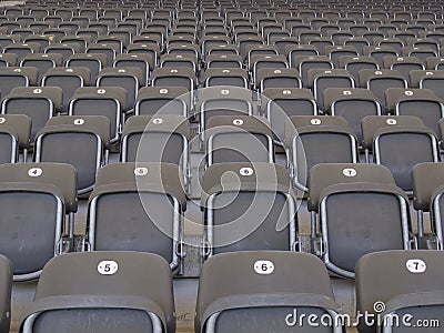 Rows of empty grey seats in an arena or stadium Stock Photo