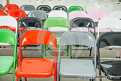 Rows of empty multicolor seats, chairs in auditorium, hall, classroom. Conference hall or seminar room. Selective focus. Stock Photo