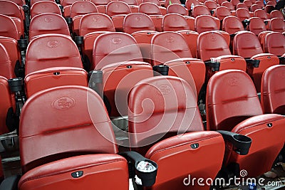 Rows of empty red stadium seats going upward Editorial Stock Photo