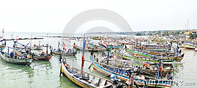 Rows of fishing boats parked on the beach during the day Editorial Stock Photo