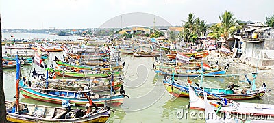 Rows of fishing boats parked on the beach during the day Editorial Stock Photo
