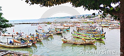 Rows of fishing boats parked on the beach in the early morning Editorial Stock Photo