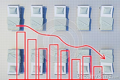 Rows of hospital beds with chart shows decline Stock Photo