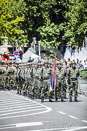 Rows of military troop marching on streets during sunny summer day Editorial Stock Photo