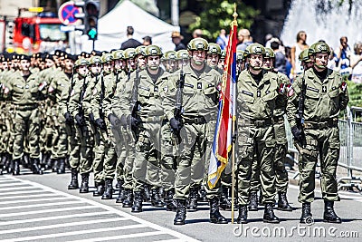 Rows of military troop marching on streets during sunny summer day Editorial Stock Photo