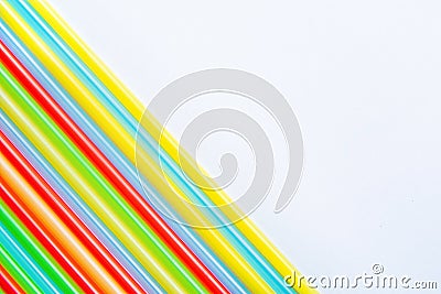 Rows of Multicolored Rainbow Drink Straws in Diagonal Corner Composition on White Paper Background.Creativity Graphic Design Stock Photo