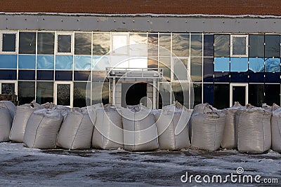 The rows of pallets with big bags in stock, for further unloading and processing . Stock Photo