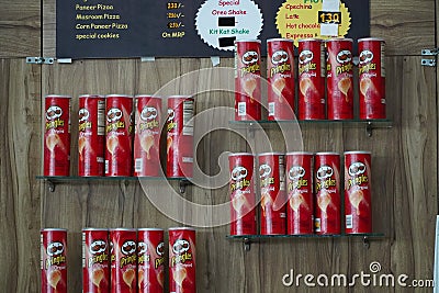 Rows of Pringles Snacks inside hypermarket. Owned by the Kellogg Company, Pringles is a brand of potato snack chips. Assorted Editorial Stock Photo
