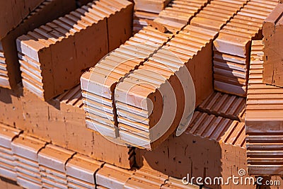 Rows of red bricks. The group or the pile of new clay red orange bricks close-up on the outside warehouse or the Stock Photo