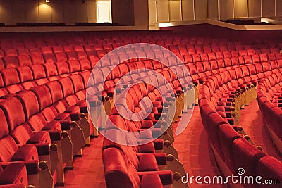 Rows of red cinema seats. View of empty theater hall. Comfort chairs in the modern theater interior Stock Photo