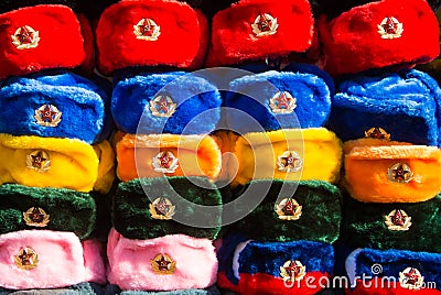 Rows of russian winter hats of different colors with army emblems at the street market at Old Arbat street Stock Photo