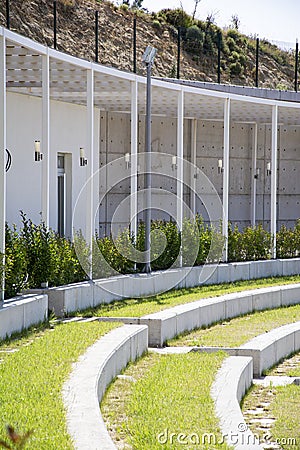 Rows of stairs and grass in the amphitheater. Modern architecture and landscape design in the park. Stock Photo