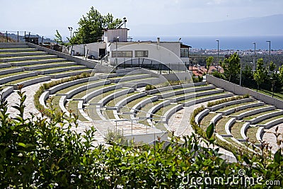 Rows of stairs and grass in the amphitheater. Modern architecture and landscape design in the park. Stock Photo