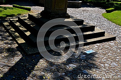3 rows of stairs in the square are gradually sunk into the paving. Slow transition of the staircase to the plane by blending, inte Stock Photo