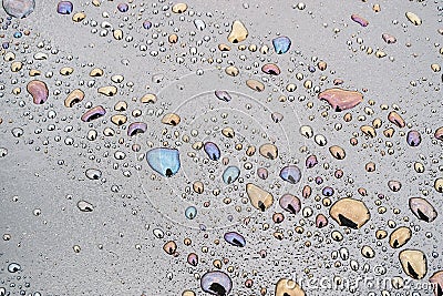 Rows of water droplets on the dark surface of bitumen, a mixture of water and petroleum macro Stock Photo