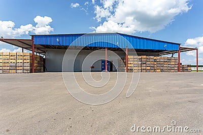 Rows of wooden crates boxes and pallets for fruits and vegetables in storage stock. production warehouse. Plant Industry Stock Photo