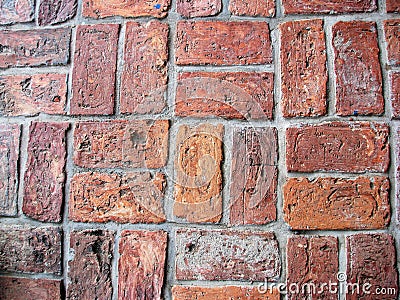 Rows of worn bricks in distinct pattern Stock Photo