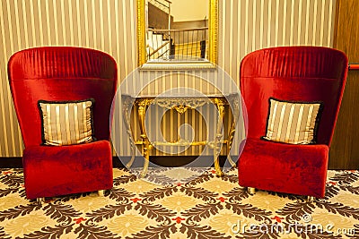 Royal Armchair in red in warm athmosphere decoration Stock Photo