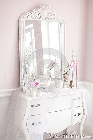 Royal bedroom. Place for make-up girls. Elegant white dressing table with mirror in light classic luxury interior. Stock Photo