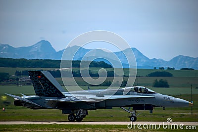 Royal Canadian Air Force CF-18 Hornet demo at Springbank Airport, Alberta rocky mountains in sight Editorial Stock Photo
