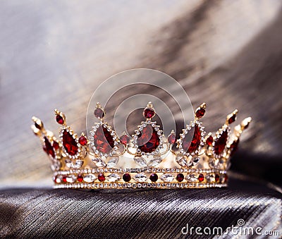 Royal crown with red stones, garnet, crystals. Stock Photo