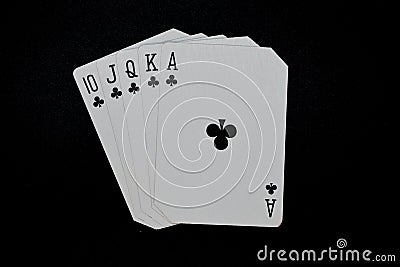 Royal Flush of clubs in poker authentic casino cards game on a black background Stock Photo