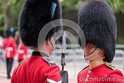 Royal Guard soldiers having an intimate conversation during the Trooping the Colour military ceremony, held once a year in London Editorial Stock Photo