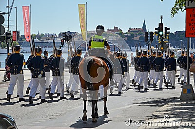 Royal Guards with police escort in Stockholm, Sweden Editorial Stock Photo