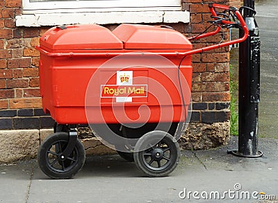 Royal Mail trolley tied to a post in the street Editorial Stock Photo