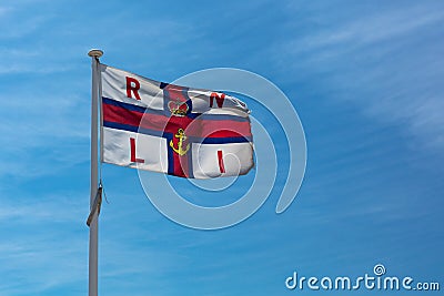 Royal National Lifeboat Institution RNLI flag flying above the lifeguard station in Southwould, UK Editorial Stock Photo