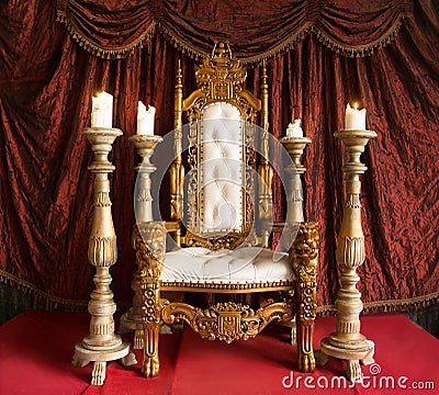 Royal throne of gold on red curtain background. Indoor Stock Photo