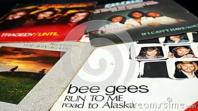 45 rpm covers of the BEE GEES group. composed of the brothers Barry, Robin and Maurice Gibb, the most successful artists in the hi Editorial Stock Photo