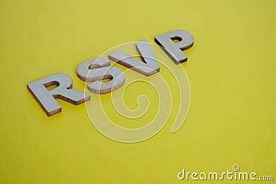RSVP wooden letters representing Please respond on yellow background Stock Photo