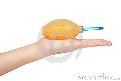 Rubber air blower, orange pump dust cleaner for camera and lenses in hand. Isolated on white background. Silicone blower Stock Photo