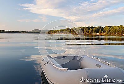 The rubber boat is tied in a picturesque bay buried in the green of a coniferous forest. Calm and rest after sea crossing. Croatia Stock Photo