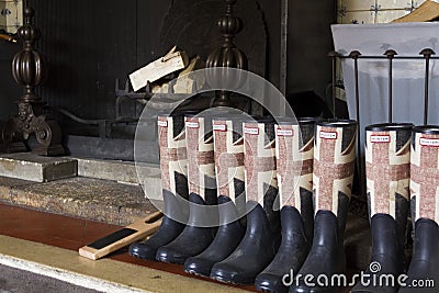 Rubber boots in front of fireplace Stock Photo
