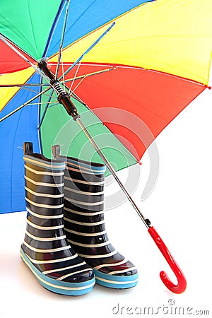 Rubber child boots with colorful umbrella Stock Photo